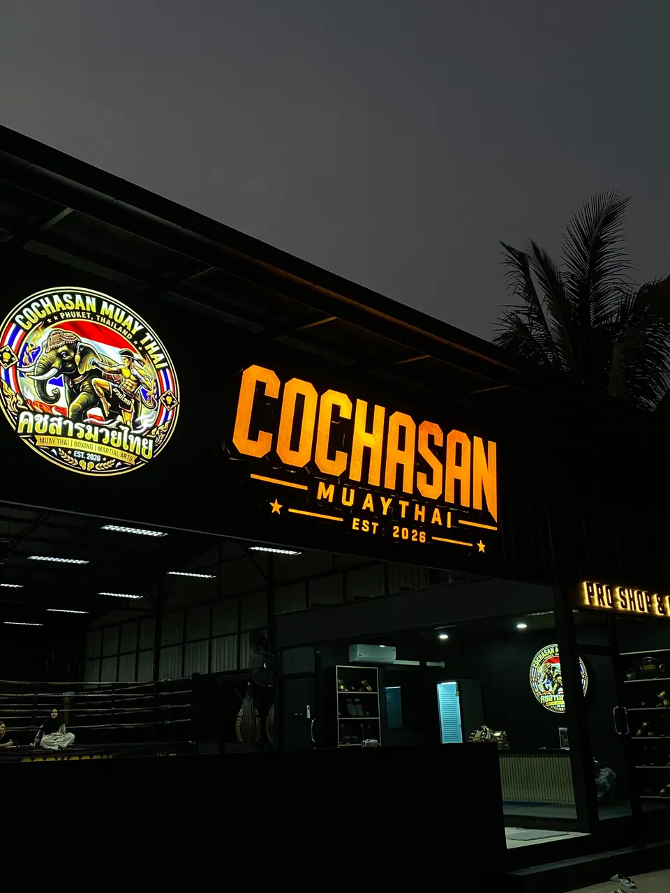 The gym at night, illuminated COCHASAN sign