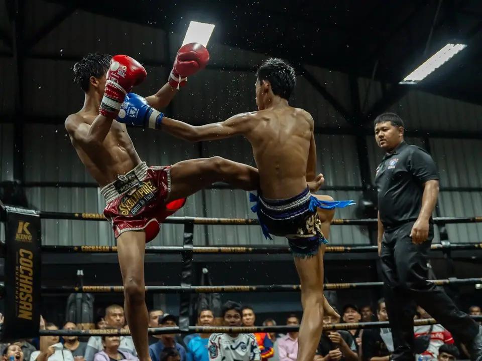A high kick during a fight night at the gym